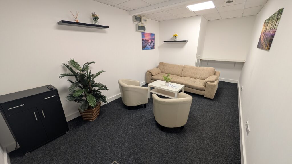 Meeting Room 1 at Waffle21 in Beverley, ideal for small meetings or therapy sessions with sofa, tub chairs, large screen TV, and free Wi-F